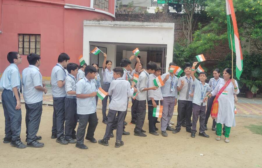 Students celebrating with the Indian flag at Adarsh New Holy Public School, Uttam Nagar