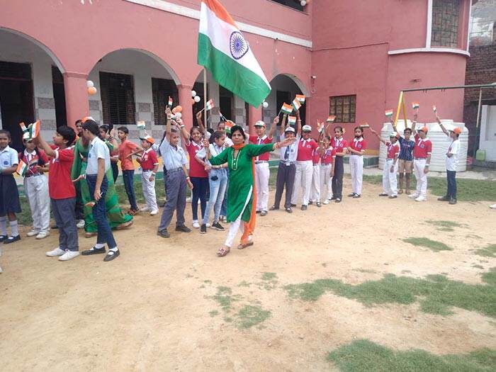 Students with the Indian flag in the school courtyard, Uttam Nagar