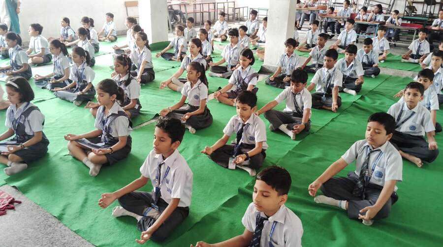 Students practising yoga on mats at Adarsh New Holy Public School in West Delhi